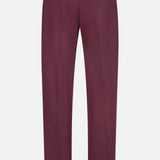 Showcased against a plain white background, the PT TORINO Stretch Overdyed Solaro Trouser Pant in burgundy features a tailored fit with belt loops and two back buttoned welt pockets—an ideal choice for polished professional attire.