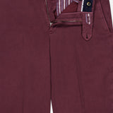 The Stretch Overdyed Solaro Trouser Pant by PT TORINO is crafted in a soft, maroon cotton-blend fabric and features a fly that unzips to reveal a striped inner lining and dark waistband. Designed with convenient buttons and belt loops, these burgundy trousers are ideal for professional dressing.