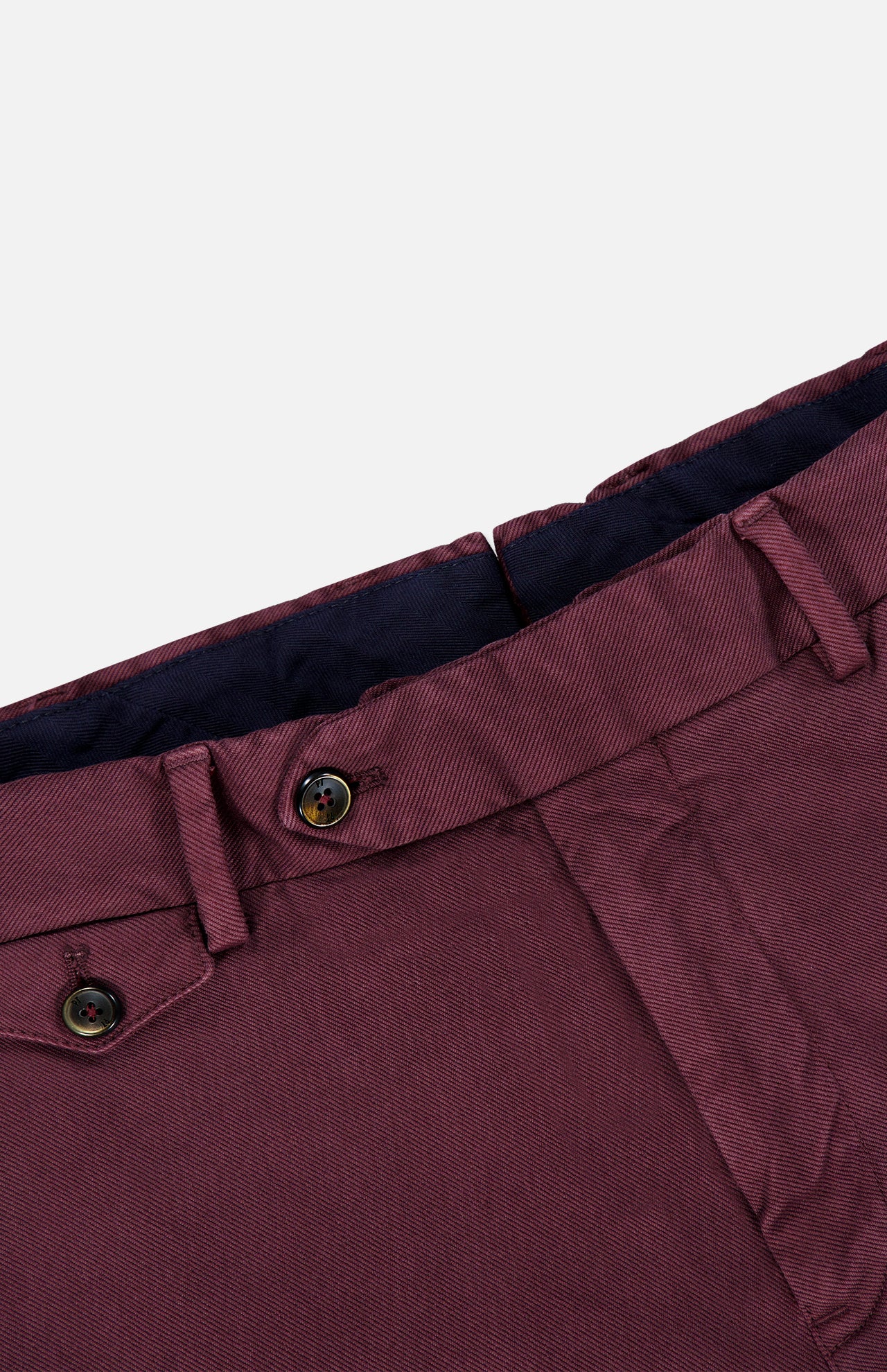 Close-up of the waistband and upper section of the PT TORINO Stretch Overdyed Solaro Trouser Pant in burgundy, featuring belt loops, buttons, and a partial view of the front pocket against a light background—a refined option for professional attire.