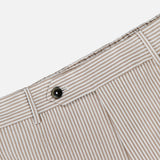 Close-up of PT TORINO's Summer Stretch Pinstripe Seersucker Slim Jogger showcasing a beige and white waistband with belt loop, black button closure, and light brown pinstripes—ideal warm weather joggers.