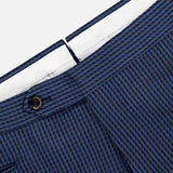 Close-up of the waistband and upper section of PT TORINO Super 100's Wool Fancy Trouser Pants in blue, featuring a textured finish, black button, and visible white inner lining.