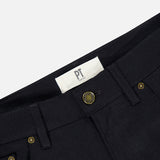Close-up of the waistband of black Wool & Cashmere Flannel Pants by PT Torino, featuring metal buttons and a white brand label.