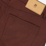 Close-up of the back of dark brown Wool & Cashmere Flannel Pants by PT Torino, featuring a patch pocket and a branded leather waistband label.