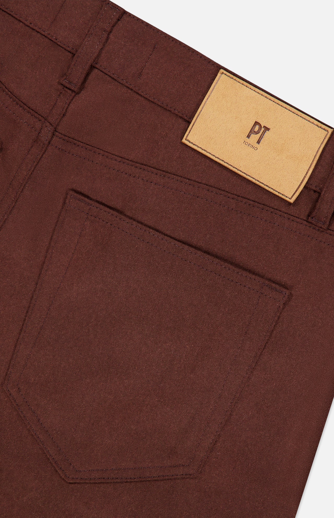 Close-up of the back of dark brown Wool & Cashmere Flannel Pants by PT Torino, featuring a patch pocket and a branded leather waistband label.