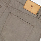 Close-up of the back of grey Wool & Cashmere Flannel Pants by PT Torino, showing a back pocket, belt loops, and a tan leather brand label.