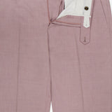 The PT TORINO Wool & Cotton Stretch Oxford Trouser Pants in light pink feature a partially open front with white lining, zipper, and button closure. Belt loops and brown buttons at the waistband provide a polished look.