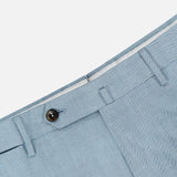 Close-up of PT TORINO Wool Blended Solaro Trouser Pants in light blue, featuring a brown button, belt loops, and fly against a white background—an elegant choice for an office chic look.