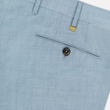 Close-up of the back pocket on PT TORINO's Wool Blended Solaro Trouser Pants, featuring a button closure, belt loops, a gold tag above the pocket, and subtly textured wool-blend fabric for effortless office chic.
