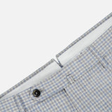 Close-up of the waistband of PT TORINO Wool Cashmere Flannel Trouser Pants in light blue and white houndstooth, with a black button closure and belt loops, set against a white background.