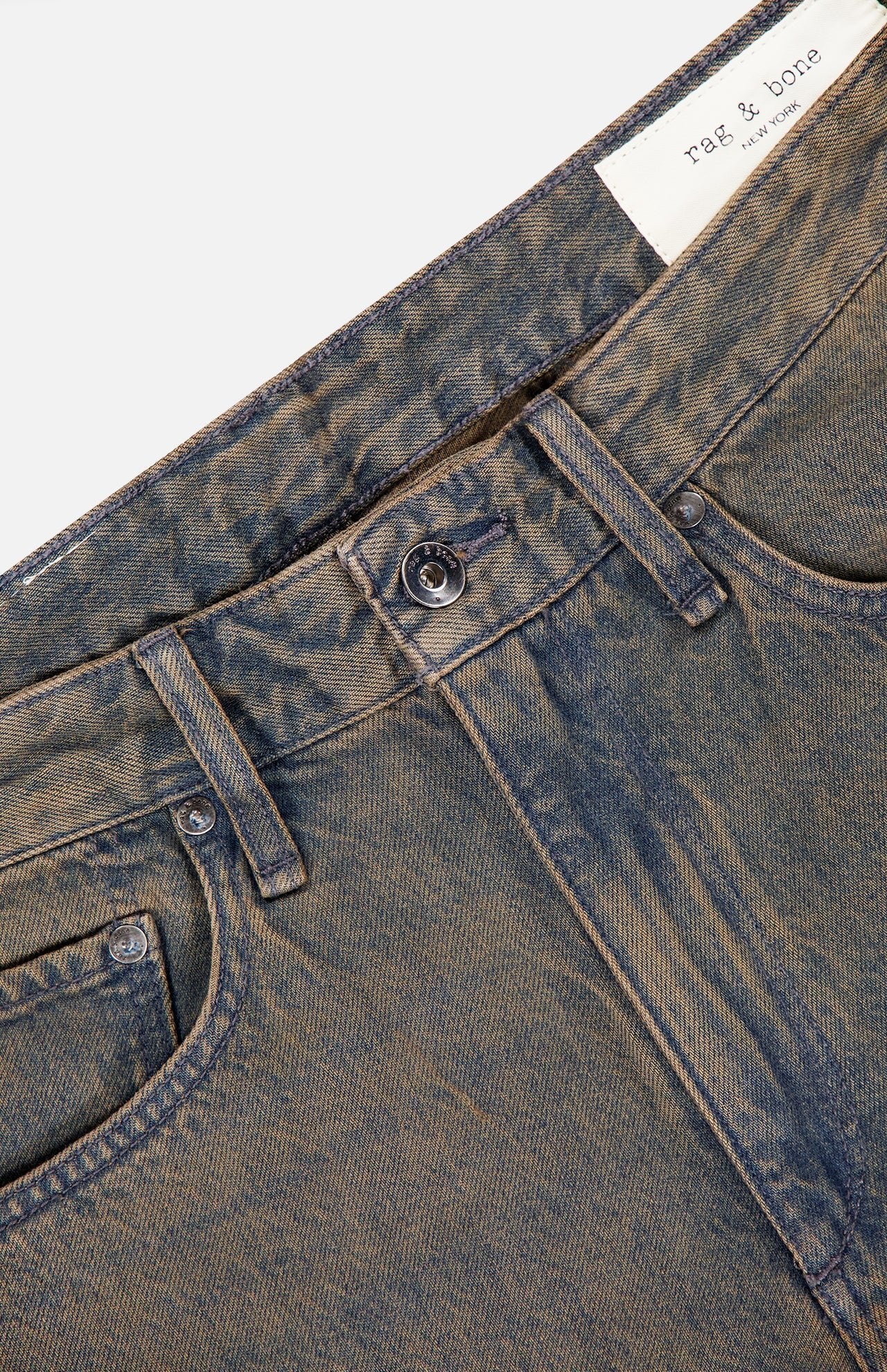 Close-up of the waistband and upper section of the RAG & BONE Rigid Fit 4 Authentic Jean in medium indigo wash, featuring a faded texture, straight leg, belt loops, button closure, and a visible brand label inside.