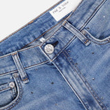 Close-up of RAG & BONE Harlow Ankle Straight Jean in light blue denim with silver studs, front pockets, belt loops, a metal button, and a white brand label on the waistband; classic straight leg design.