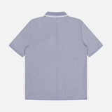Back of the Harvey Tipped Polo Shirt by RAG & BONE, a retro-inspired, light blue short-sleeve polo with white pinstripes and classic collar, displayed on a plain white background.