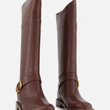 The RAG & BONE Hayden Leather Riding Boot is a tall brown leather boot with low heels and gold buckles on side straps, shown against a plain white background.