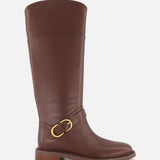 The Hayden Leather Riding Boot by RAG & BONE is a knee-high brown leather boot with a low stacked heel and gold buckle detail near the ankle, shown against a plain white background.