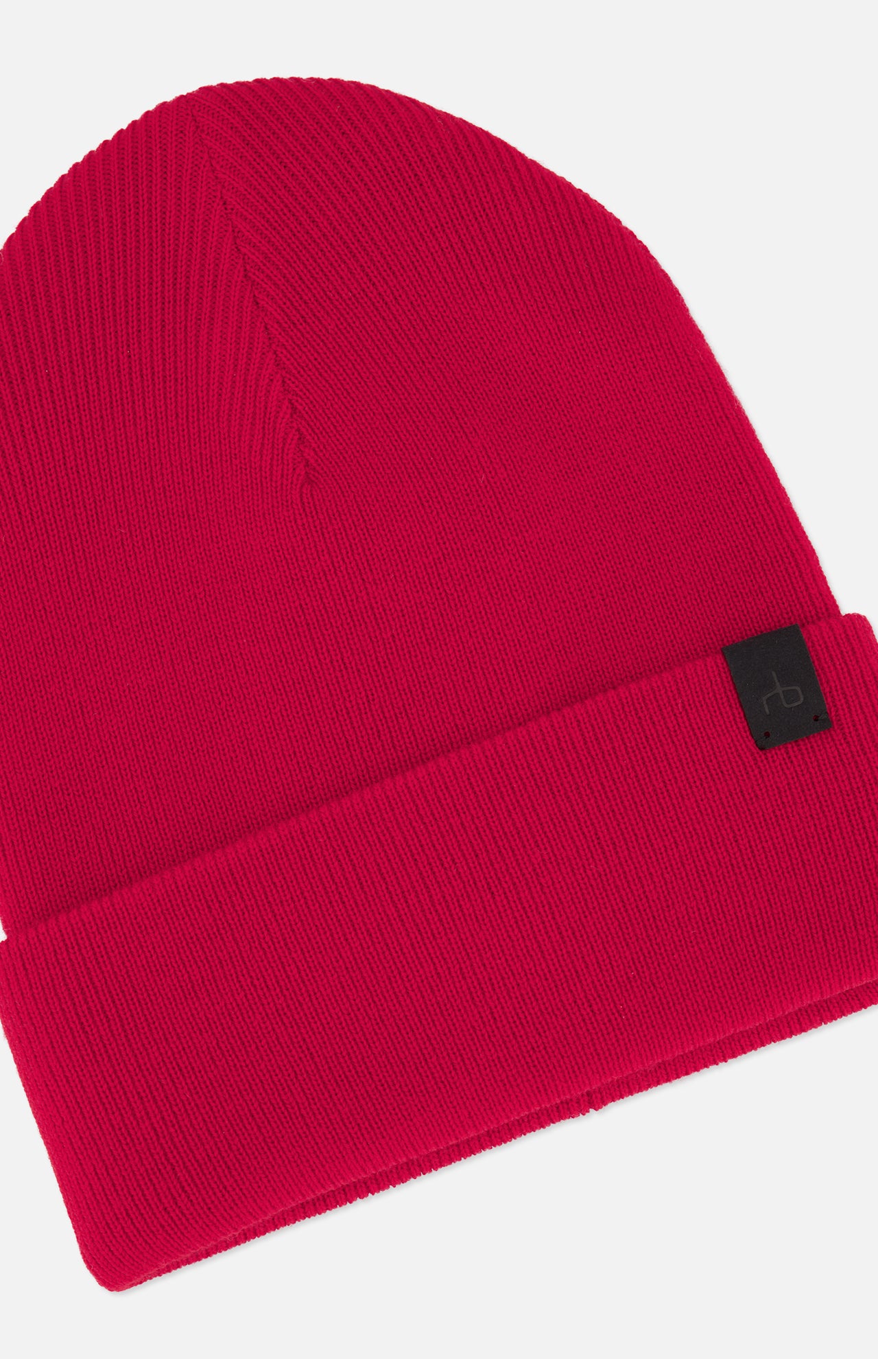 The Brooks Stretch Beanie by RAG & BONE is a vibrant red ribbed knit with a folded brim and a small black logo tag, shown against a plain white background.