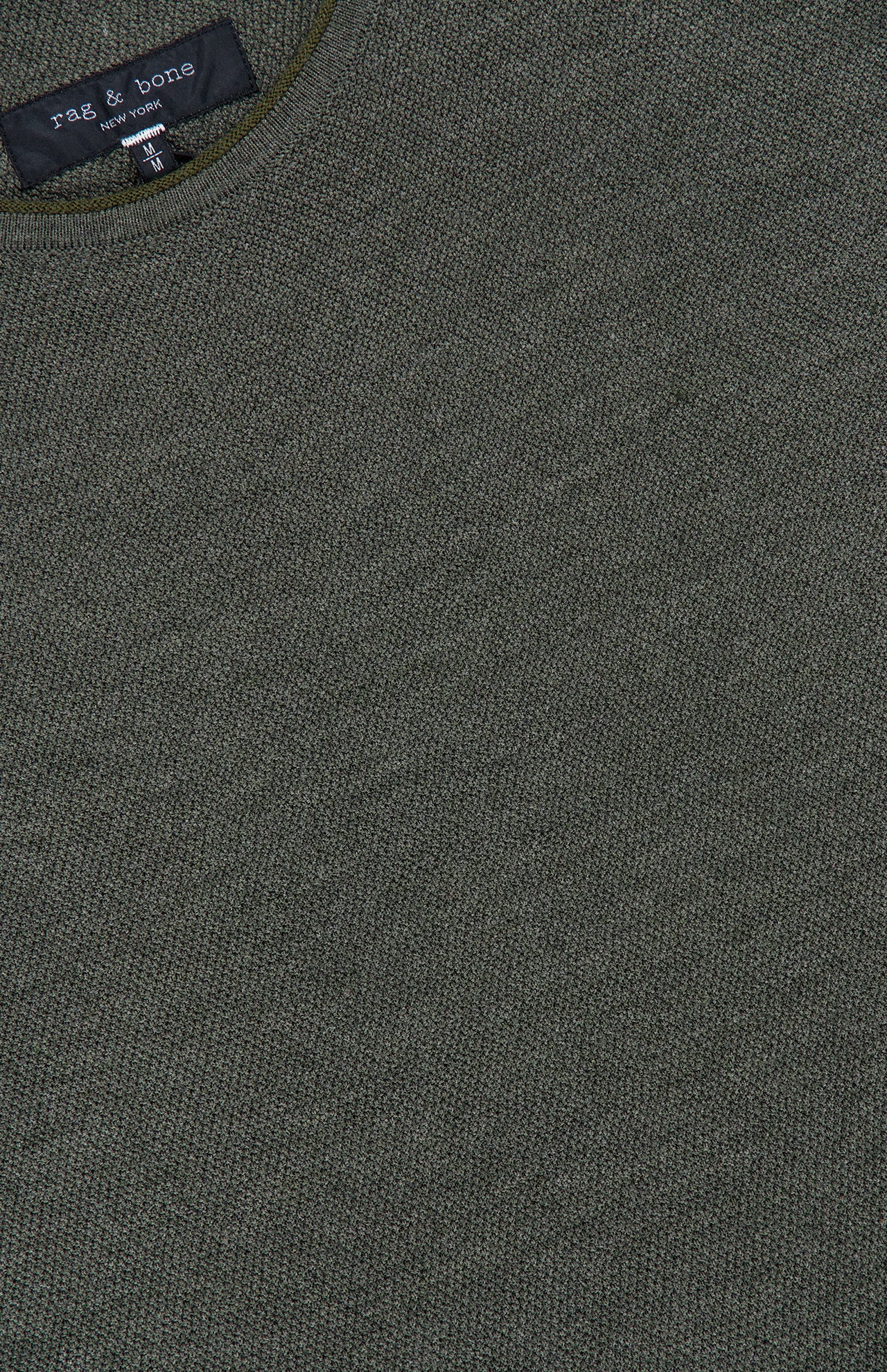 Close-up of a textured army green Brooks Wool Crew Neck Sweater with a visible RAG & BONE label near the collar, highlighting the refined details of this men’s crew neck sweater.
