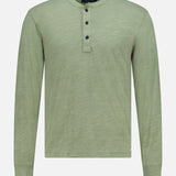 The RAG & BONE Classic Flame Henley Shirt in light green features a round neckline and three dark buttons on a short placket, making it an ideal casual wardrobe staple. Crafted from soft cotton, this plain Henley shirt has no visible patterns or logos and is displayed against a clean white background.