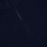 Close-up of the RAG & BONE Danton Cotton Quarter Zip Sweater in navy. Features a textured knit, silver quarter-zip collar, and lightweight cotton with subtle raised details.