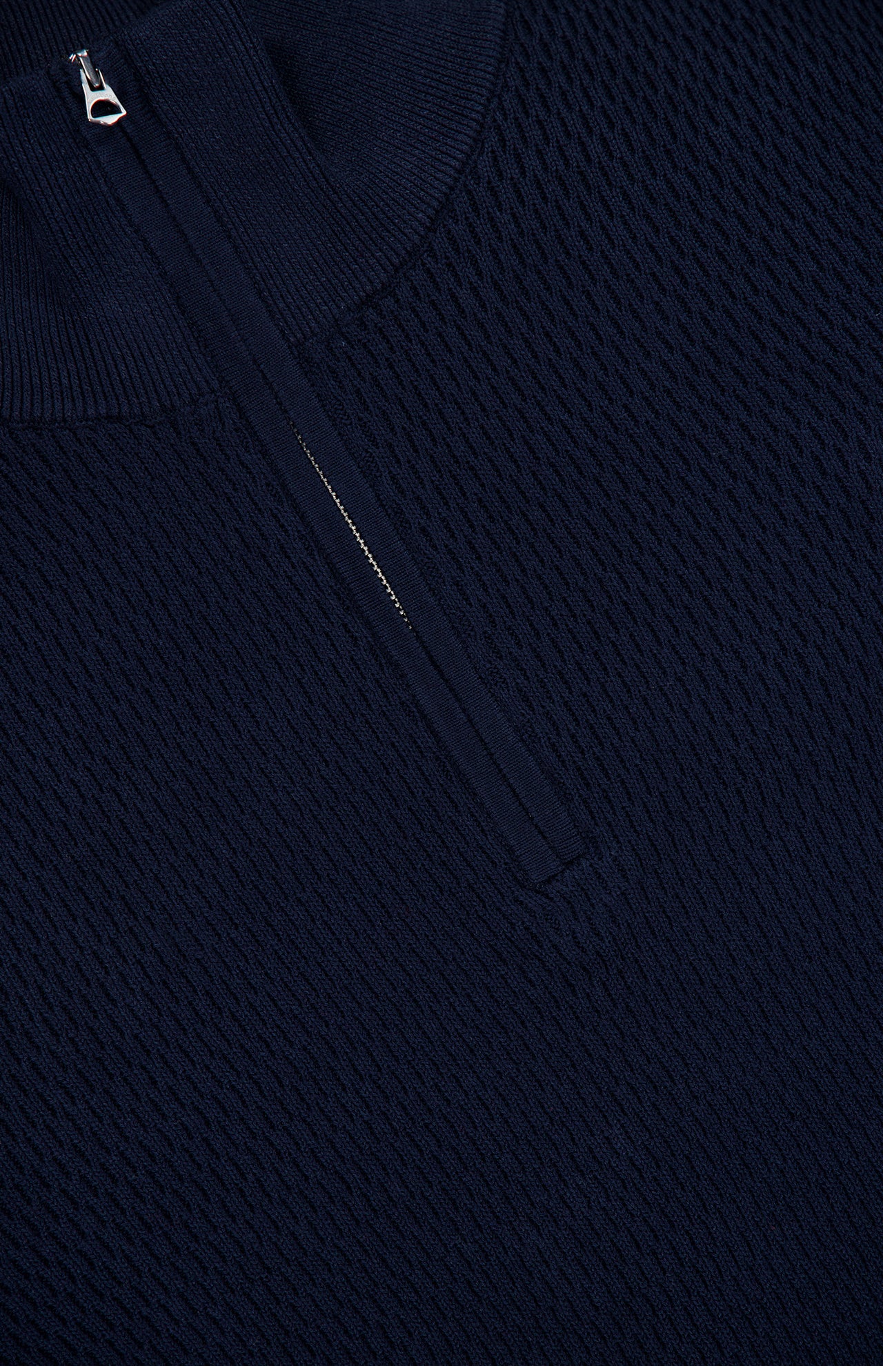 Close-up of the RAG & BONE Danton Cotton Quarter Zip Sweater in navy. Features a textured knit, silver quarter-zip collar, and lightweight cotton with subtle raised details.