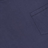 Close-up of the RAG & BONE Garment Dye Classic Pocket T-shirt in navy, featuring a right chest pocket, visible collar, and a label at the top left of this men's casual shirt.