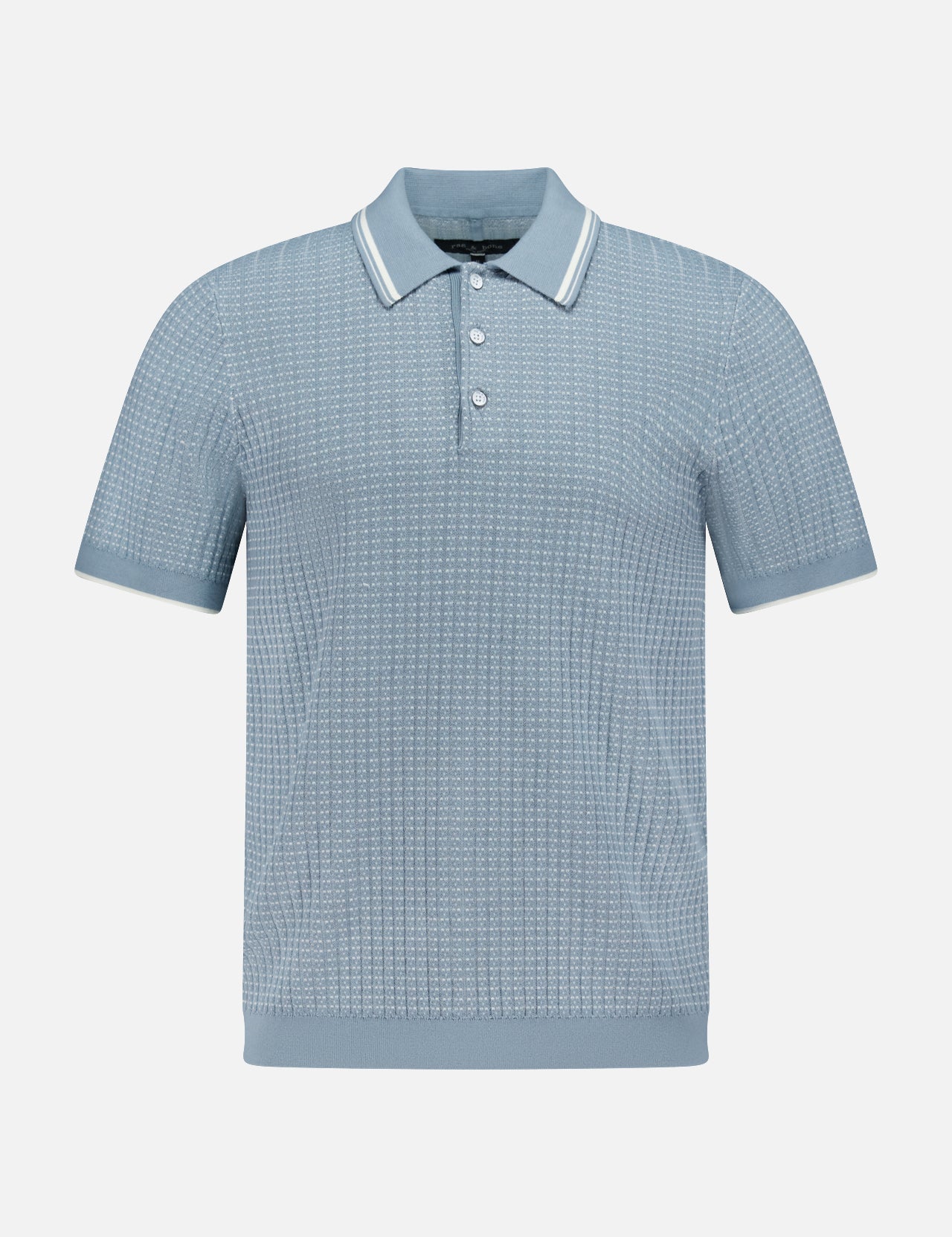 The Harvey Rib Polo Shirt by RAG & BONE features a light blue-grey hue, textured retro-inspired stitch, short sleeves, a three-button placket, and a collar with white stripe trim. Displayed on a plain white background.