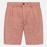The RAG & BONE Jackson Pleated Linen Short in light pink features a classic fit, belt loops, front pleats, button closure, and zip fly, shown against a plain white background.