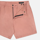 The Jackson Pleated Linen Short by RAG & BONE in pink features a classic fit, partially open zipper and button closure, visible waistband, and front pocket. The shorts are laid flat against a white background.