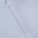 Close-up of the RAG & BONE RB Classic Striped Oxford Shirt, showcasing blue stripes, white buttons, a button-down collar, diagonal fabric pattern, and a partial shirt label visible at the top left.