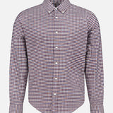 The Classic Oxford Dress Shirt by RAG & BONE features long sleeves, a button-up front, and a collared neckline. Showcasing a subtle small checkered pattern in shades of red, white, and blue, this shirt is crafted from 100% cotton and is presented against a plain white background.
