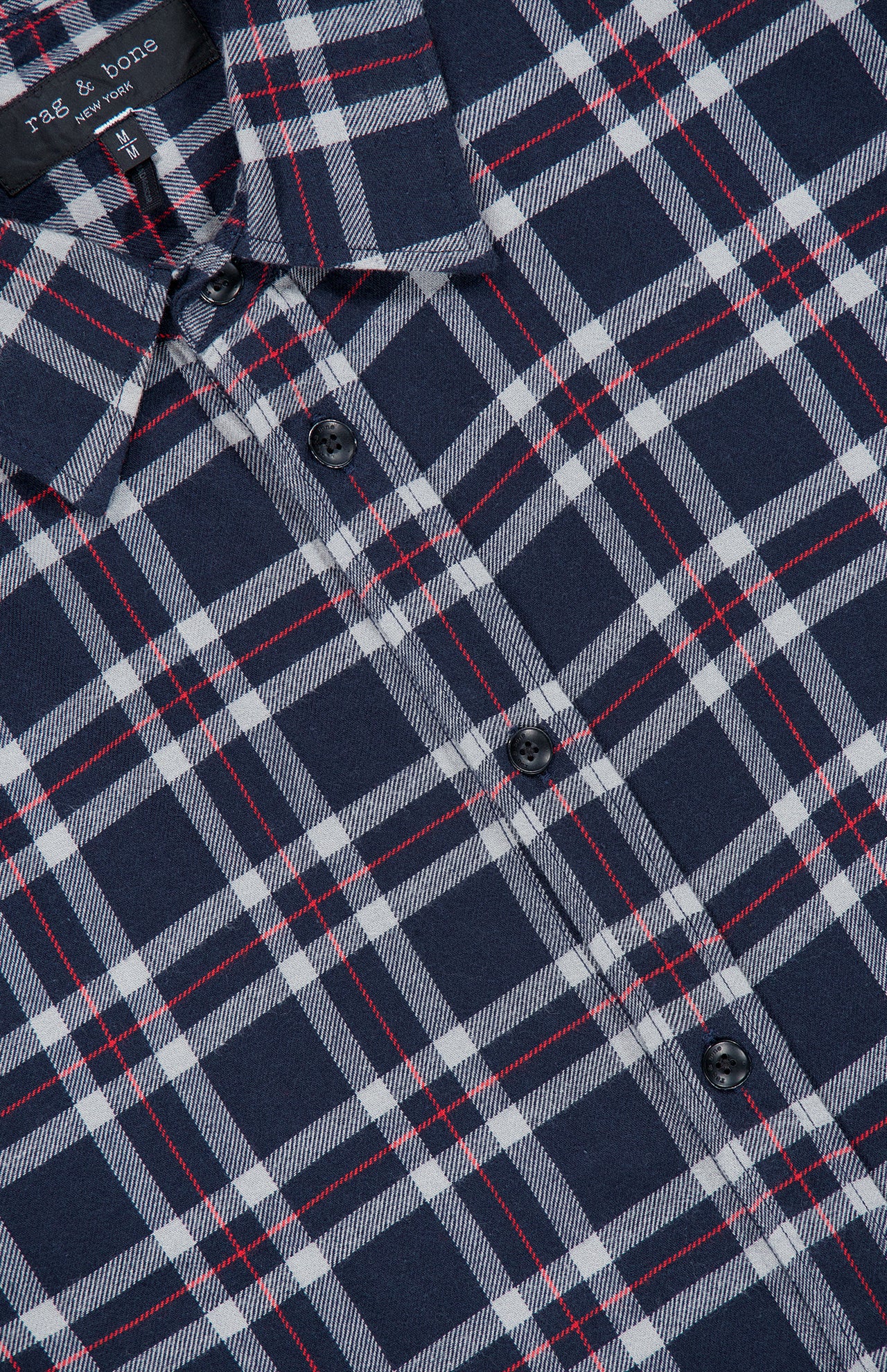 Close-up of a navy blue, white, and red plaid Tomlin Flannel Shirt by RAG & BONE, featuring a visible collar, black buttons, and neck tag.
