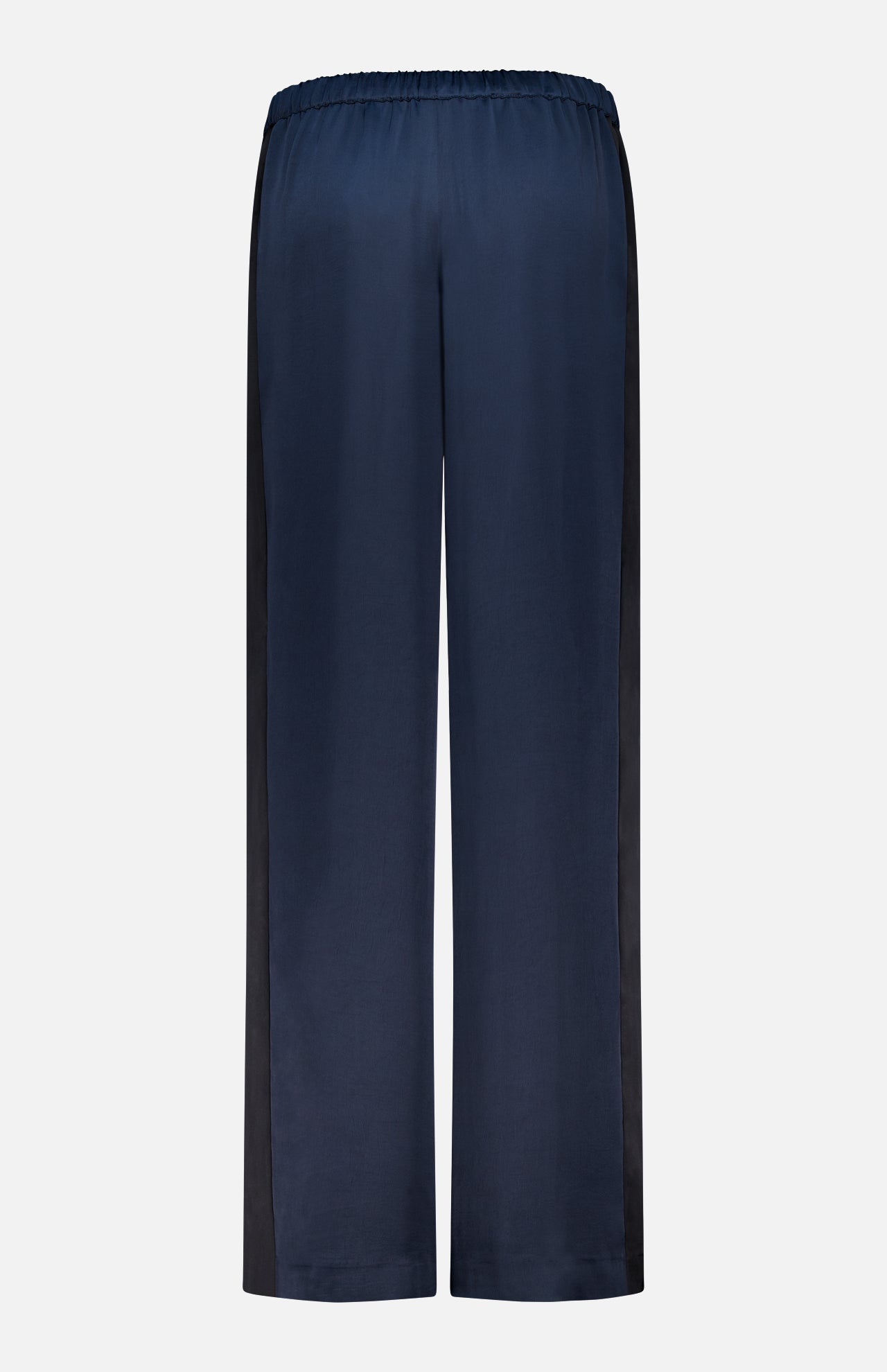 Back view of the RAG & BONE Olivia Contrast Stripe Pant in relaxed fit navy satin, featuring an elastic waistband and black side panels, shown on a plain white background.
