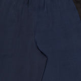 Close-up of the Olivia Contrast Stripe Pant by RAG & BONE, featuring a relaxed fit, elastic waistband, and black side panels for a sleek, minimal look with smooth navy fabric.