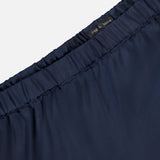 Close-up of the waistband of the Olivia Contrast Stripe Pant by RAG & BONE, featuring a relaxed fit, elastic band, and visible black brand label. The smooth navy fabric appears lightweight.