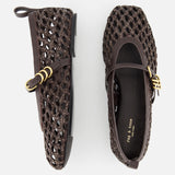 The Spire Mary Jane Faux Leather Flats by RAG & BONE are dark brown woven shoes with gold buckles, a basket-like texture, closed heel, and back loop. Shown on a white background with one flat top view and one side view.