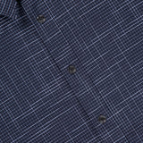 Close-up of the Tomlin Crosshatch Pattern Shirt by RAG & BONE, a navy modern fit with thin white grid lines, three black buttons, and part of the collar for a sharp, contemporary look.