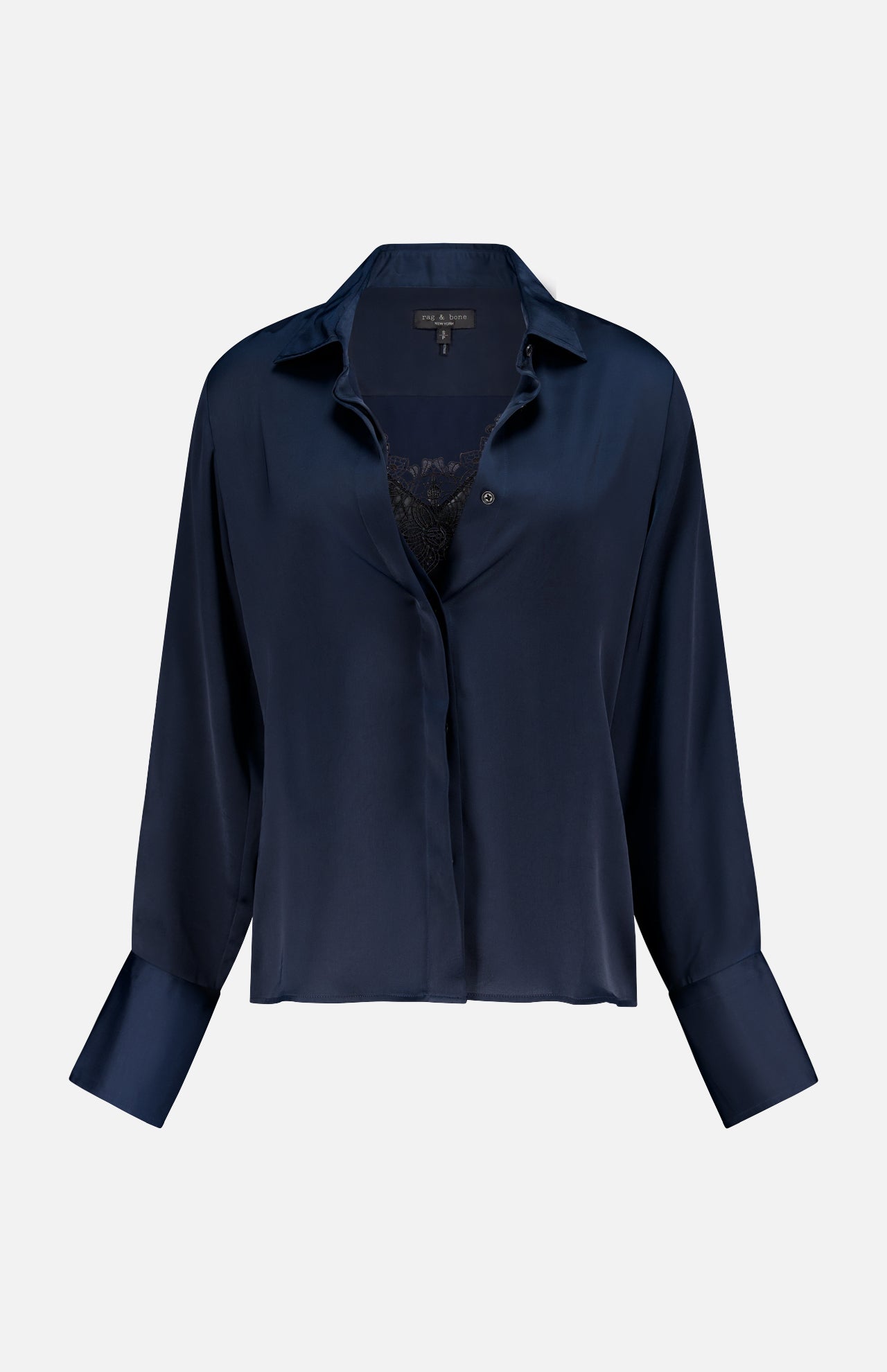 The RAG & BONE Venus Popover Removable Cami Blouse is a dark navy satin, long-sleeved, collared top with wide cuffs, a loose fit, and an open front that reveals a hint of black lace. Features a removable camisole for versatile styling.