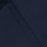 Close-up of the Venus Popover Removable Cami Blouse by RAG & BONE in dark navy, featuring a hidden button placket and smooth, satin-like fabric. Brand tag is visible at the neckline.