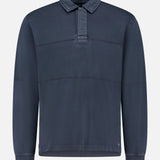 The RAG & BONE Washed Rugby Long Sleeve Polo Shirt features a dark blue cotton fabric, collared pullover design, short button placket, and subtle horizontal seams, shown against a plain white background.