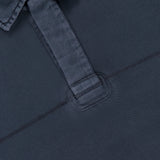 Close-up of the Washed Rugby Long Sleeve Polo Shirt by RAG & BONE in navy blue cotton, featuring a partial placket, visible stitching, and a black "rag & bone new york" collar tag with XL size label.