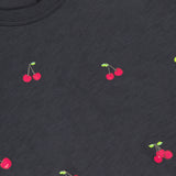 The All Over Cherry T-shirt by RAG & BONE features a playful black cherry print with red cherries and green stems, crafted from soft Peruvian cotton for comfort and style.