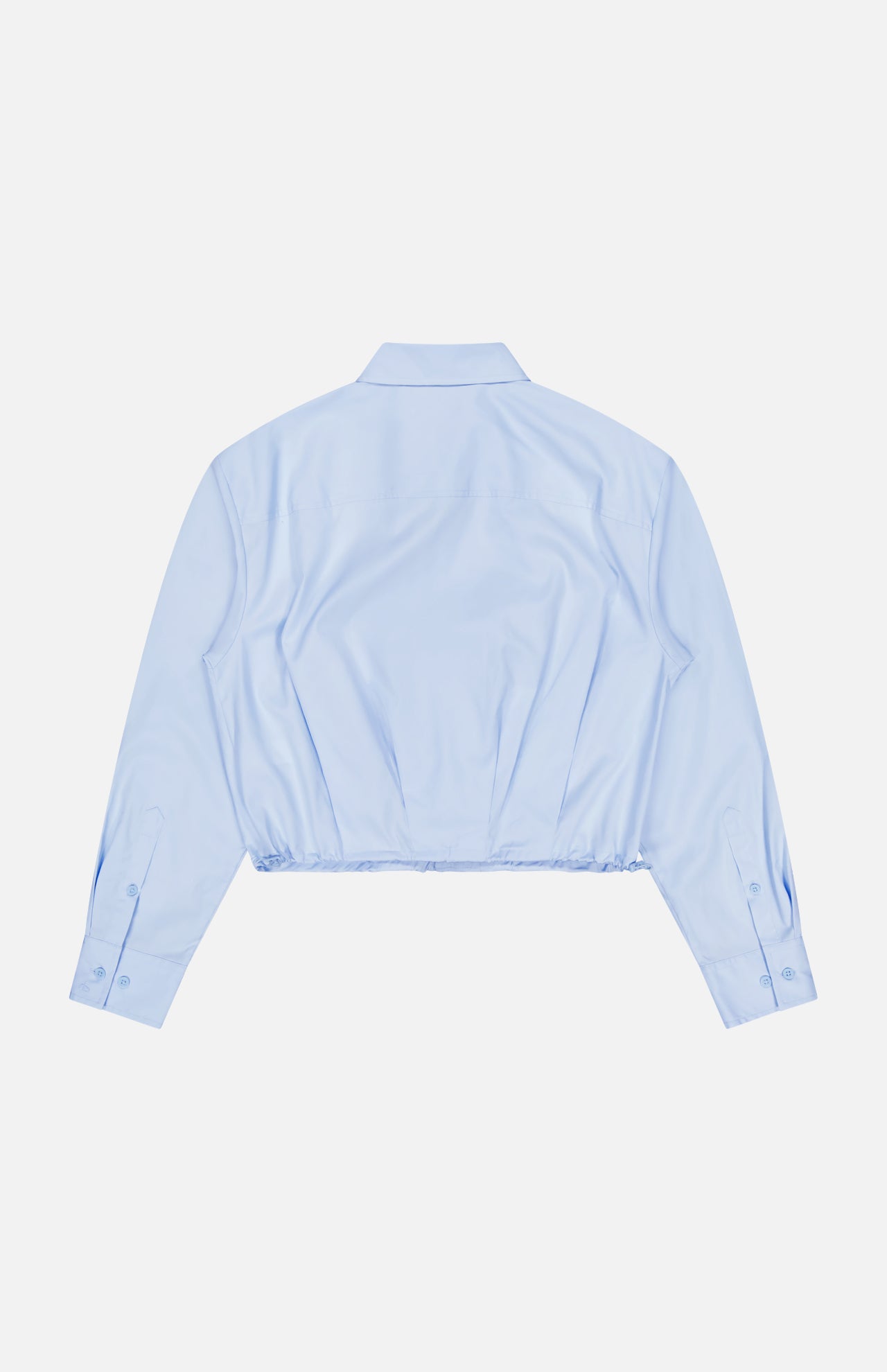 The Andy Pleated Drawcord Top by RAG & BONE is a light blue, long-sleeve cropped shirt with a collared neckline and buttoned cuffs, shown from the back on a white background. This cotton blouse brings a modern edge to the classic button-down.