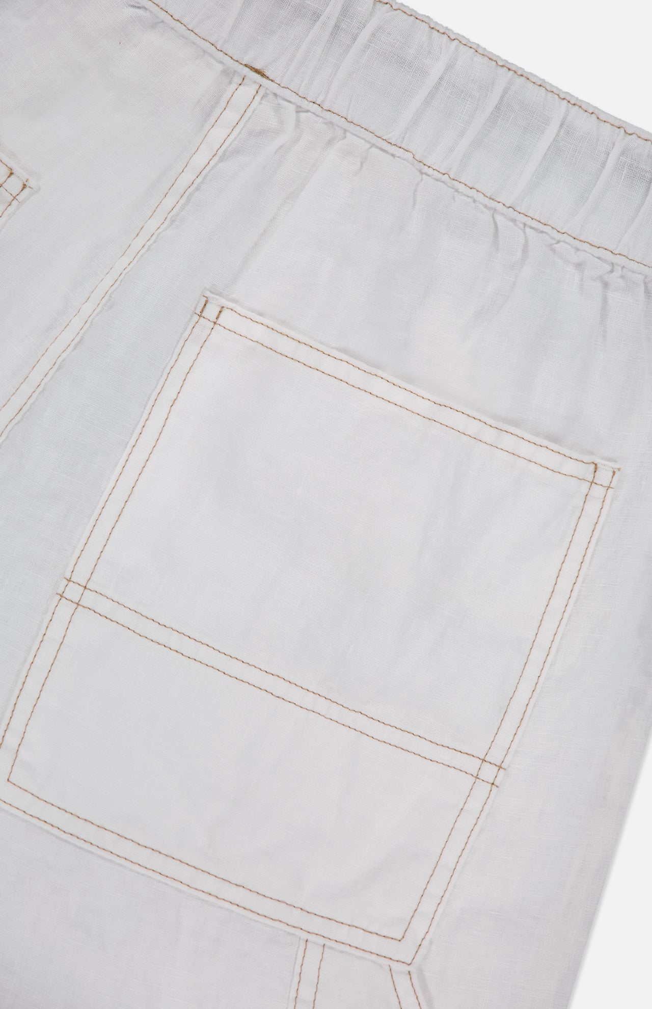 Close-up of the RAG & BONE Atlas Drawcord Linen Pant, featuring a white linen fabric, elastic waistband, and a large square pocket with visible tan stitching in a rectangular pattern. High-rise design adds to its modern look.