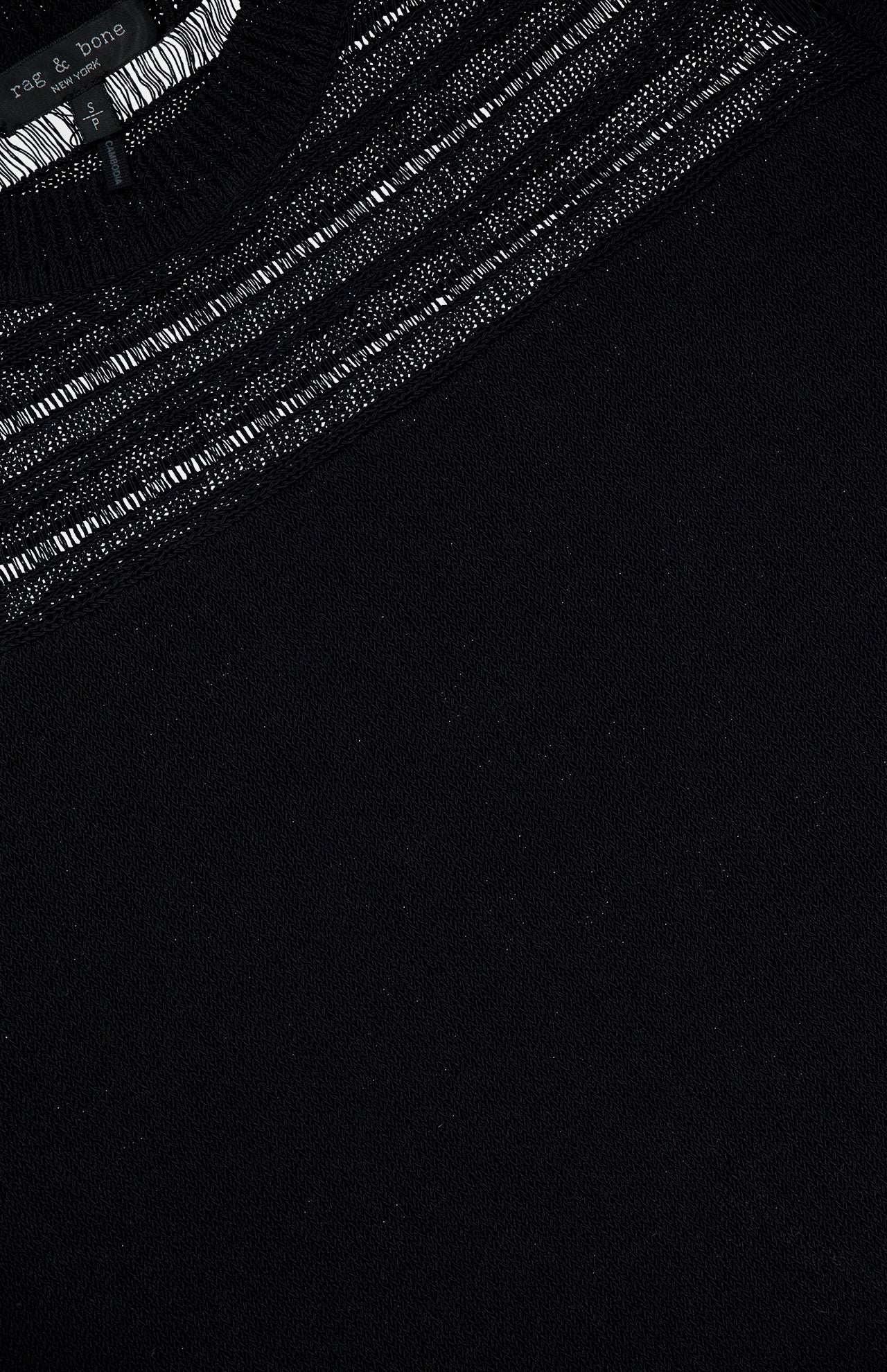 Close-up of a black lightweight cotton-blend Britt Short Sleeve Crewneck T-shirt by RAG & BONE, featuring sheer drop-needle stripes near the neckline and a small brand tag at the collar.
