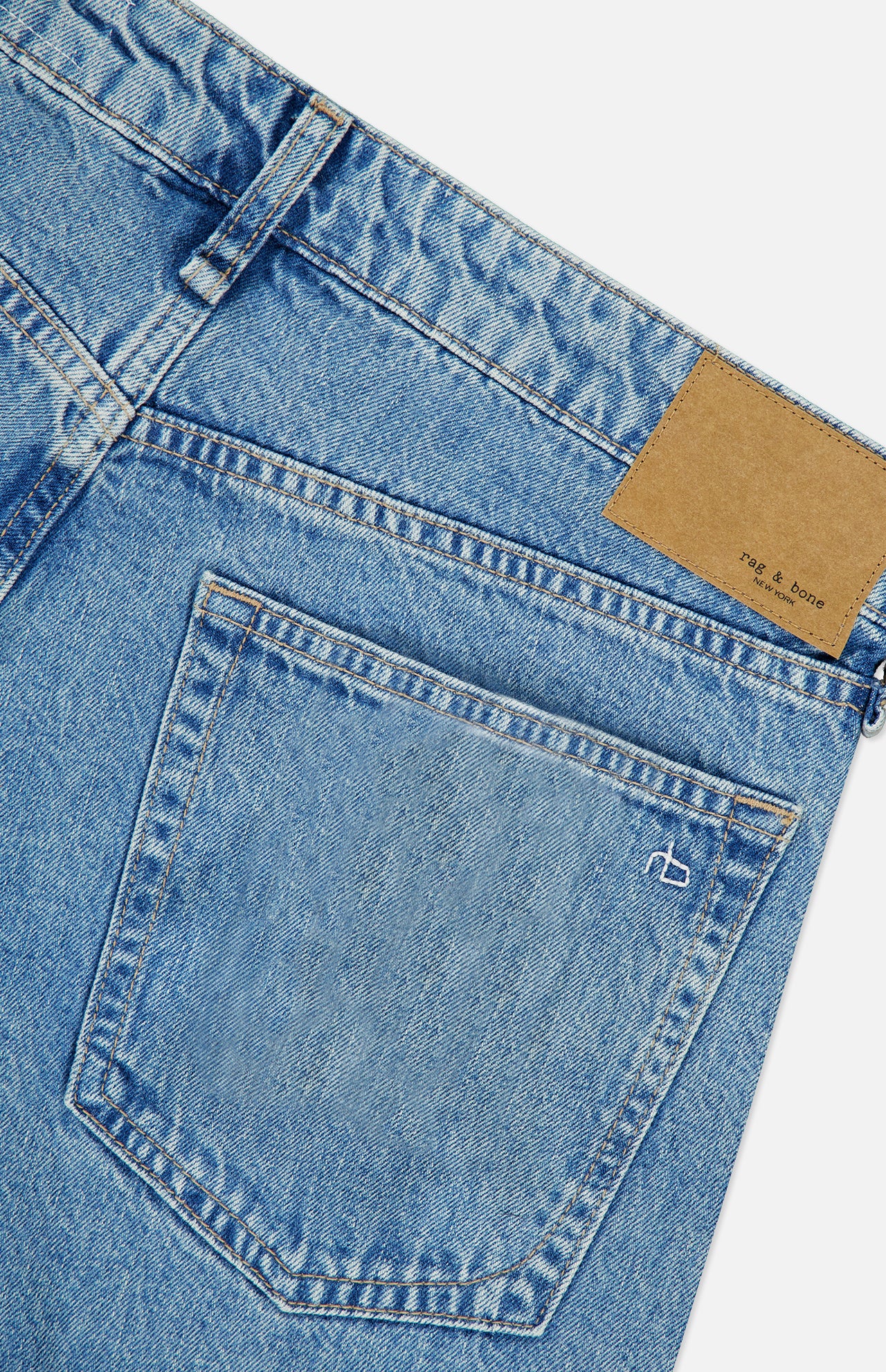 Rag & Bone Cam Full Straight Jean in Dekalb Jewel: light blue low-rise straight leg jeans featuring a tan leather patch on the waistband and an embroidered logo on the back pocket.