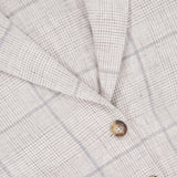 Close-up of the Chappell Plaid Linen Blazer by RAG & BONE, featuring a beige plaid pattern with thin grey lines, two brown buttons, and a visible black size tag labeled 2 near the collar for versatile style.