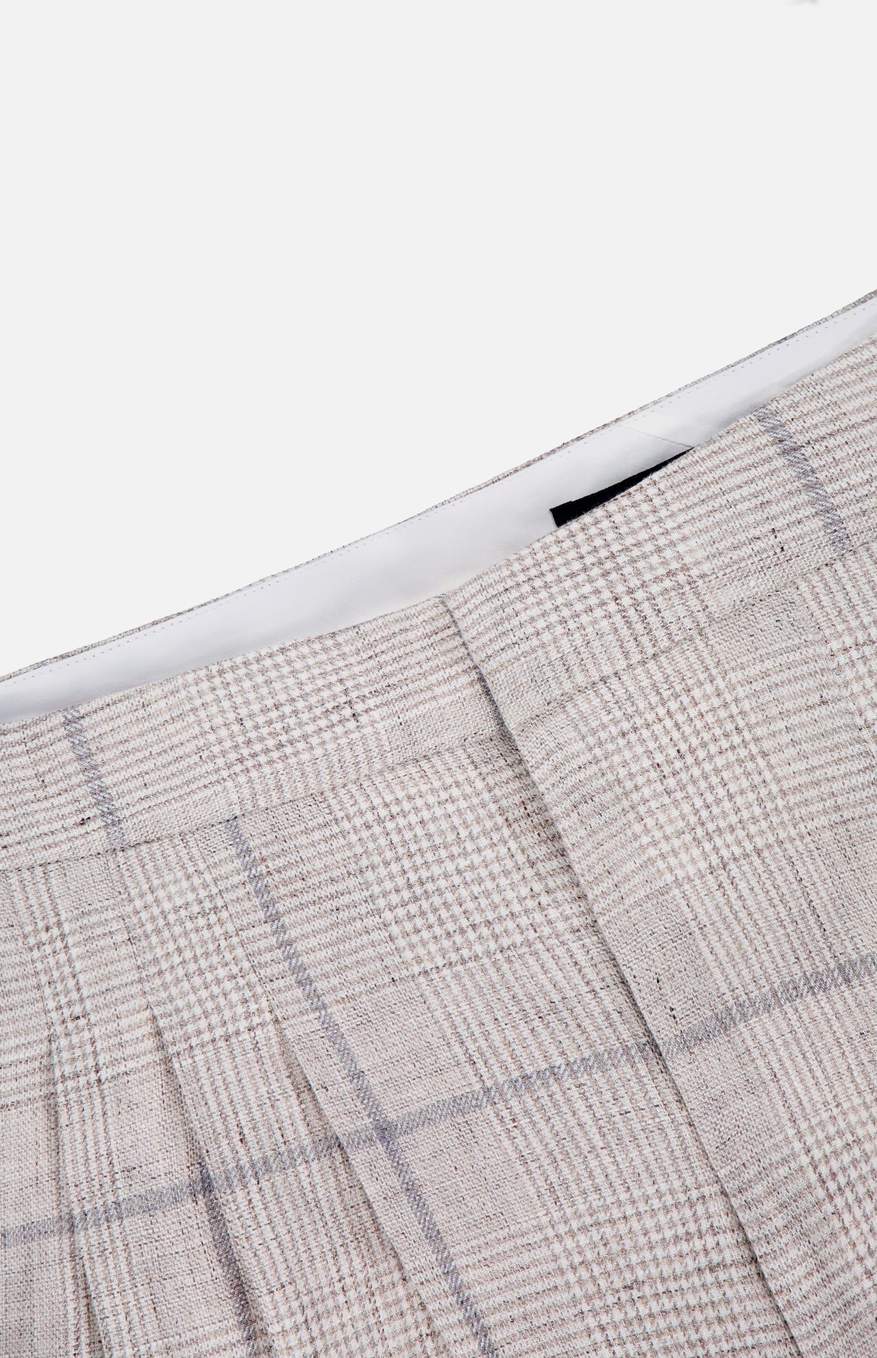 Close-up of the RAG & BONE Chappell Plaid Linen Pant in light beige with gray stripes, featuring pleats and a defined waistband—ideal for sophisticated styling—set against a white background.