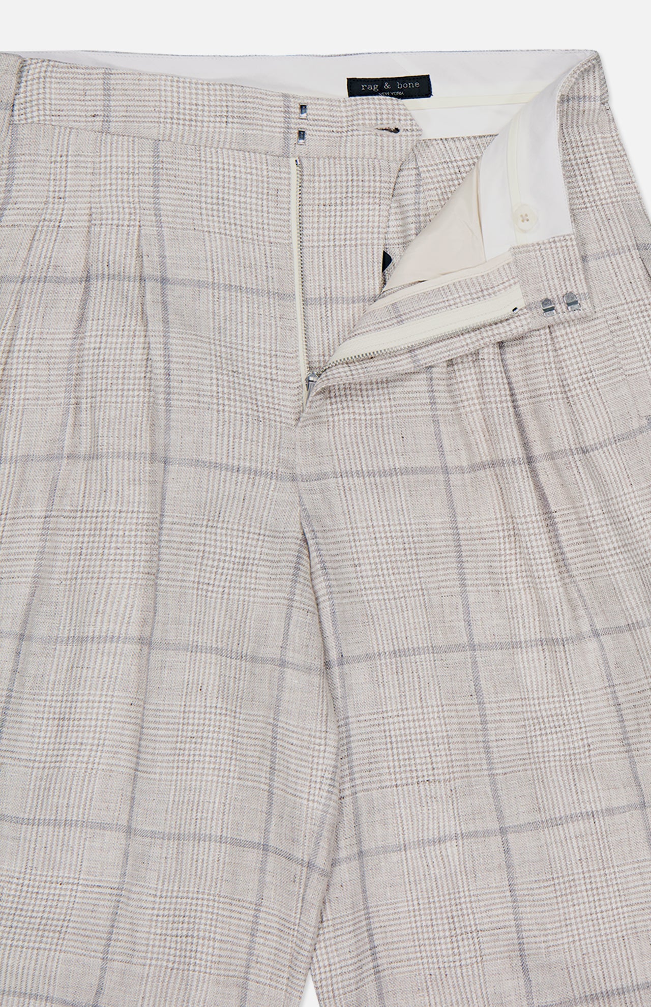 The RAG & BONE Chappell Plaid Linen Pant features a light beige plaid pattern, high-rise fit, zipper fly with button closure, and a partially open waistband that shows the inner lining and label.