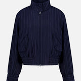 The Eliza Striped Bomber Jacket by RAG & BONE features navy with white pinstripes, long sleeves, high collar, elastic cuffs, gathered hem, two front pockets, a cropped cut, and a relaxed fit.