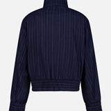 The Eliza Striped Bomber Jacket by RAG & BONE features navy blue fabric, thin white pinstripes, long sleeves, and elastic cuffs and waistband, shown from the back against a plain white background.