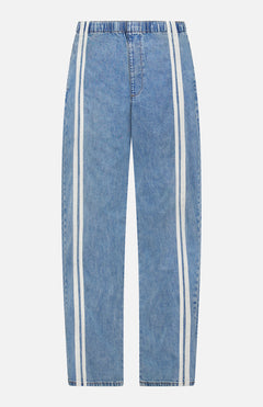 The Featherweight Logan Track Pant in Eversport by RAG & BONE features light blue denim, relaxed fit, elastic waistband, and wide straight legs with two parallel white stripes along the outer sides from waist to hem.